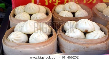 Wangfujing Snack Street. Street food booth selling specialty Chinese Steamed Dumplings in Beijing Located in Beijing China.
