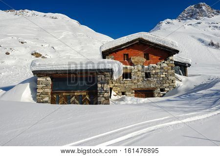 Alpine winter mountain landscape. French Alps covered with snow in sunny day. Val-d'Isere, France