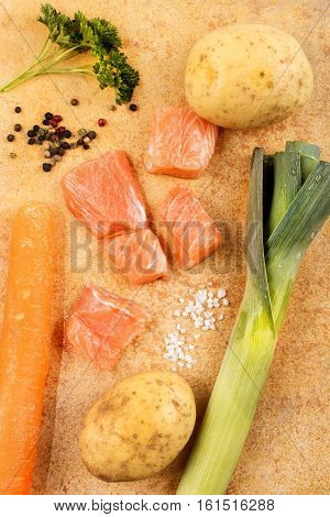 salmon chunks leek potato carrot parsley and pepper to make a fish soup