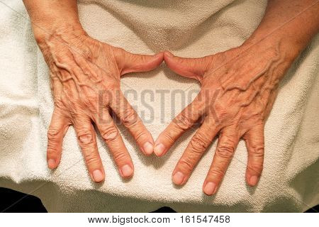 The grandmother hands on a black background. The life and old age