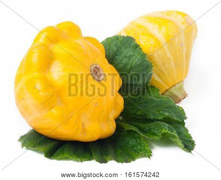two yellow pattypan squash with leaf isolated on white background.