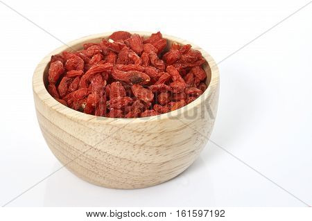 goji berry in wooden cup on white background.