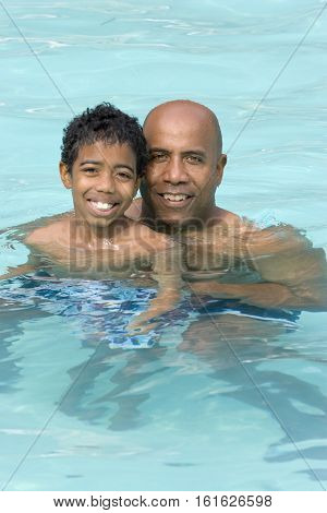 Portrait of an African American father and son outside at the park.