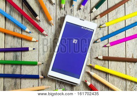 BUNGKAN THAILAND - NOVEMBER 10 2015: smart phone with facebook logo on screen and color pencil around