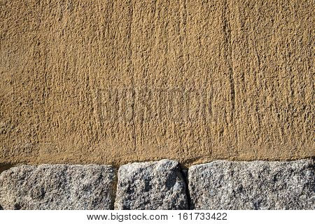 Garden wall made of a mix of stone block and sand stone