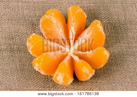 Tangerine on a linen background made of cloth. Fresh ripe fruit diet vitamins.