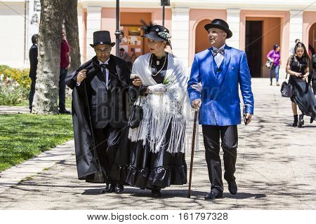 CAGLIARI, ITALY - May 29, 2016: Sunday at La Grande Jatte VIII Ed. At the Public Gardens - Sardinia - group of people parading in Victorian costumes