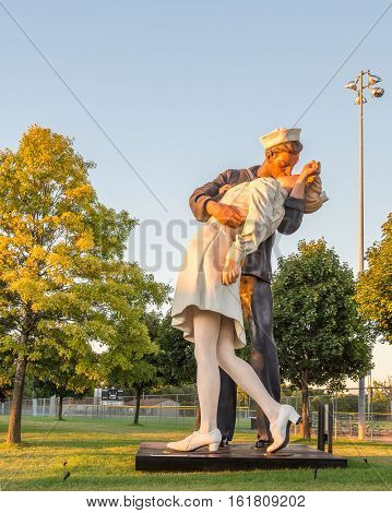 ROYAL OAK MI/USA - AUGUST 22 2016: Sunlight falls on the Victory in Europe (VE) Day statue on Woodward Avenue at Memorial Park. The statue is a rendition of the Alfred Eisenstaedt photograph of a Navy man kissing a woman in New York's Times Square at the
