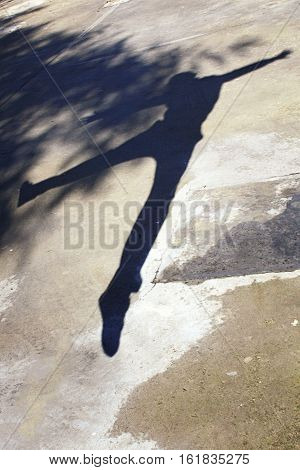 Bouncing boy reflected a shadow on the ground