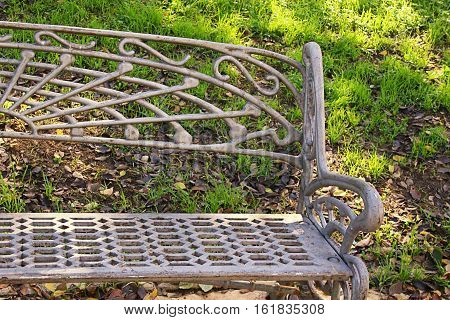 iron leisure bench in the autumn Park