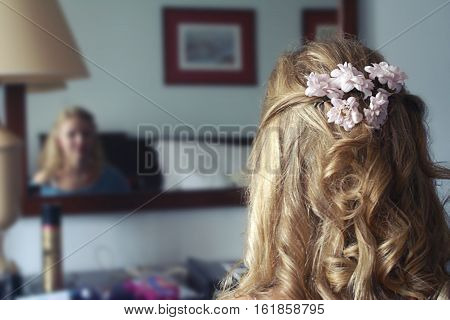 curly hair girl back view decorated with flowers