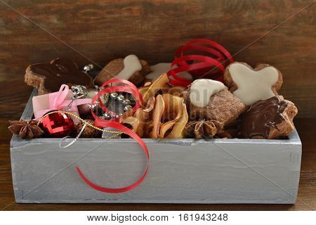 Christmas cookies nuts spices and decoration in a wooden box