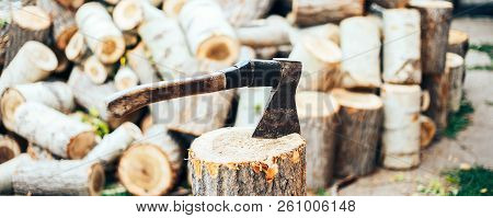 A Sharp Blade Of An Ax That Sticks Out In A Wooden Chock. Rustic Concept