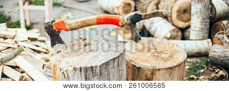 A Sharp Blade Of An Ax That Sticks Out In A Wooden Chock. Rustic Concept