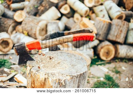A Sharp Blade Of An Ax That Sticks Out In A Wooden Chock. Rustic Concept