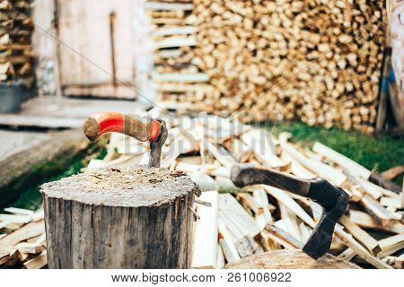 A Sharp Blade Of An Ax That Sticks Out In A Wooden Chock. Rustic Concept