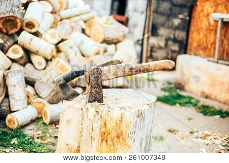 A Sharp Blade Of An Ax That Sticks Out In A Wooden Chock. Rustic Concept