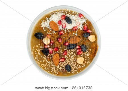 Overhead View Of Delicious Asure Bowl Filled With Nuts And Fruit. White Coconut Powder Sprinkled On 