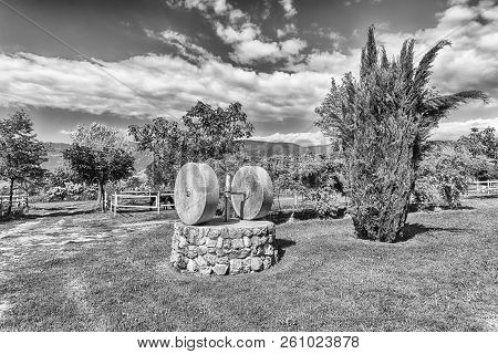 Ancient Olive Press With Two Millstones In The Countryside
