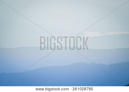 A Dreamy, Hazy Landscape Of A Mountains Close To Sunset. Sun Flase And Misty Look In Blue Tones. Mo