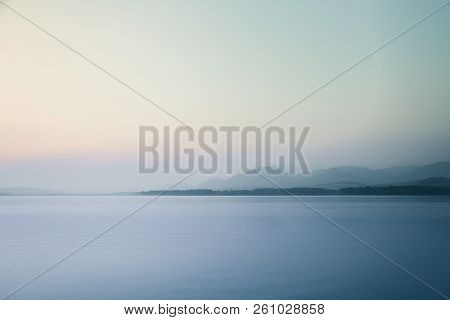 A Dreamy, Hazy Landscape Of A Mountains Close To Sunset. Sun Flase And Misty Look In Blue Tones. Mo