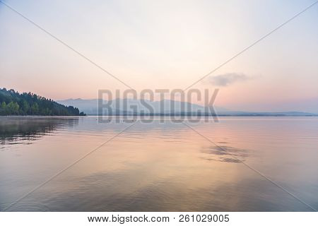 A Beautiful, Calm Morning Landscape Of Lake And Mountains In The Distance. Colorful Summer Scenery W