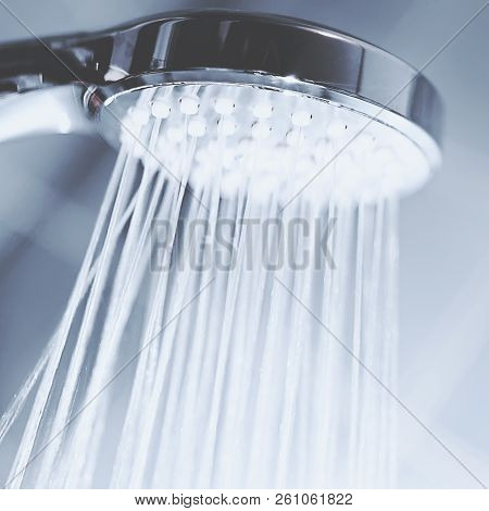 Shower Head With Flow Of Water Spilling Out Closeup.
Modern Shower Head Splashing Water Close Up.