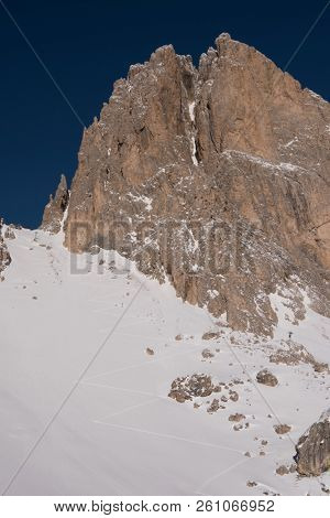 hiking touring ski tracks in snow climbing to mountain top at beautiful winter day with fresh snow
