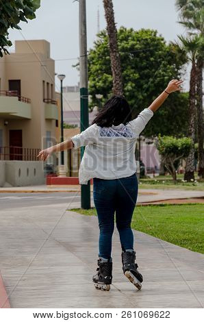 Very Beautiful Happy Chubby Woman With Her Inline Skates