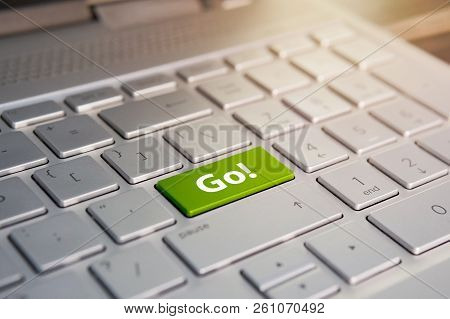 Word Go Written On A Green Computer Keyboard Key Or Button. Color Button On The Gray Silver Keyboard