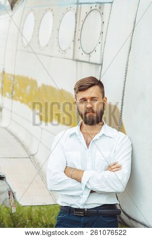 The Man In The Shirt Stands At The Old Plane