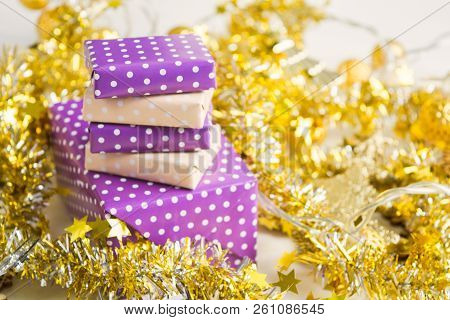 Beige And Violet (purple) Gift Boxes (presents) Stack With Ribbon With Golden Christmas Decoration