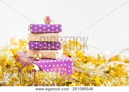 Beige And Violet (purple) Gift Boxes (presents) Stack With Ribbon With Golden Christmas Decoration