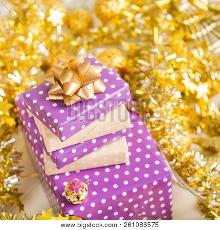 Beige And Violet (purple) Gift Boxes (presents) Stack With Ribbon With Golden Christmas Decoration