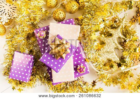 Beige And Violet (purple) Gift Boxes (presents) Stack With Ribbon With Golden Christmas Decoration
