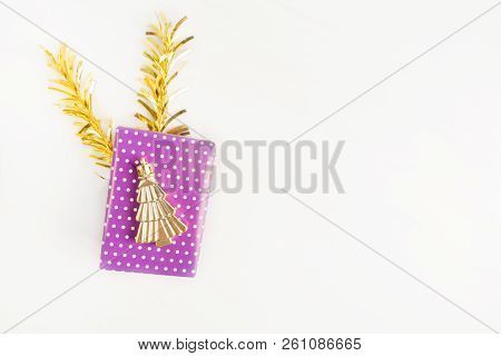 Violet (purple) Gift Box With Christmas Symbol Tree On It With Golden Decoration On Light Background