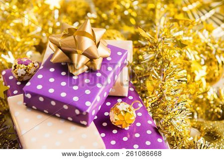 Beige And Violet (purple) Gift Boxes (presents) Stack With Ribbon With Golden Christmas Decoration