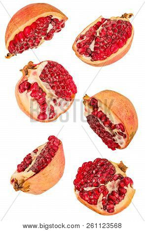 Creative Fruit Concept. Pomegranates Halves Flying In The Air Isolated On White With Clipping Path. 