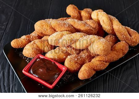 Twisted Korean Doughnuts - Kkwabaegi Sprinkled With Sugar And Served With With Chocolate Sauce On A 
