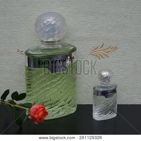 Eau De Rochas, Fragrance For Ladies, Large Perfume Bottle Next To A Commercial Perfume Bottle In Fro