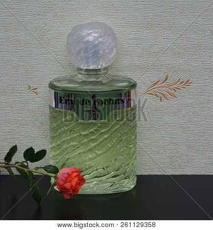 Eau De Rochas, Fragrance For Ladies, Large Perfume Bottle In Front Of The Satin Wallcovering Elysee 