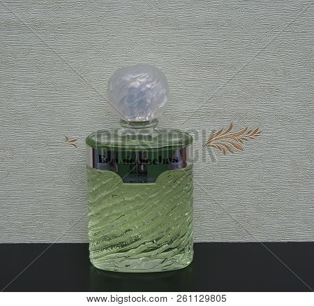 Eau De Rochas, Fragrance For Ladies, Large Perfume Bottle In Front Of The Satin Wallcovering Elysee
