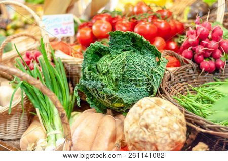 Savoy Cabbage And Other Fresh Vegetables For Sale In A Parisian Food Market