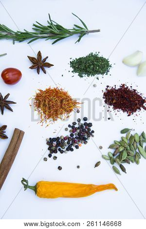 Dry Spices And Herbs In Glass Jar With A Cork, A Bowl Of Cherry Tomatoes And Chili Peppers, White Ba