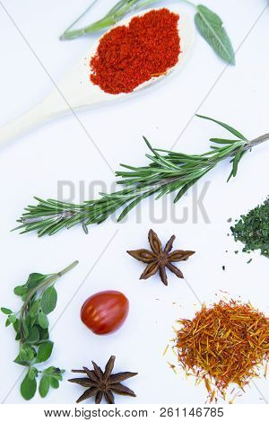 Dry Spices And Herbs In Glass Jar With A Cork, A Bowl Of Cherry Tomatoes And Chili Peppers, White Ba