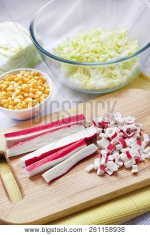 Surimi Sticks Cut On Wooden Cutting Board. Process Of Cooking Chinese Cabbage, Sweet Corn And Surimi