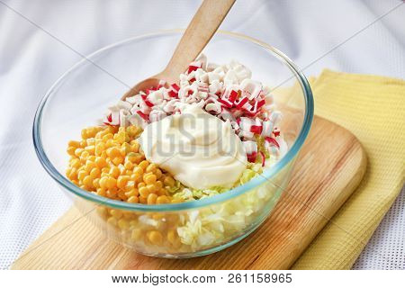 Ingredients In A Glass Bowl. Process Of Preparing Chinese Cabbage, Sweet Corn And Surimi Salad