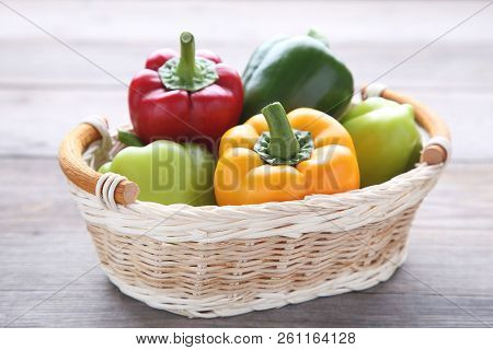 Fresh Pepper In A Basket On Grey Background.red, Green, Yellow Paprika On Table.