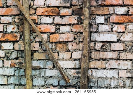 Photo Texture Of The Old Weathered Brick Wall And With The Letter 