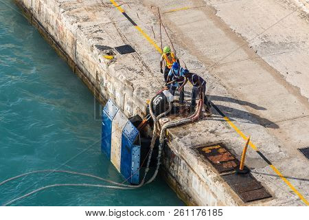 Bridgetown, Barbados - December 18, 2016: Port Workers On Mooring Rope Of A Ship In Harbor Of Bridge